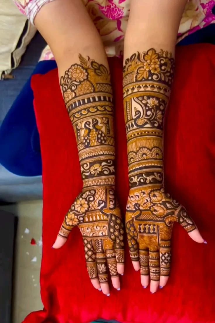Detailed bridal mehandi with doli and shehnai figures up to the elbow